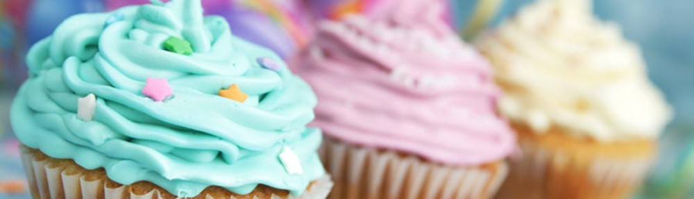 Banner photo of various colorful cupcakes.